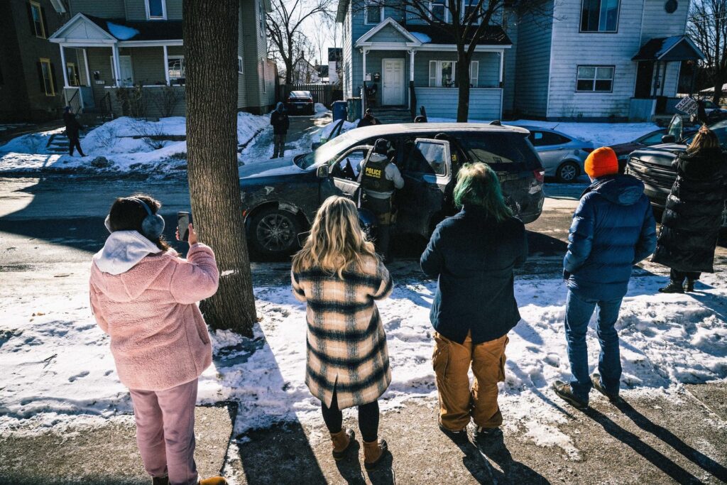 People videotaping and ICE vehicle by Dave Decker/ZUMA Press Wire/Alamy
