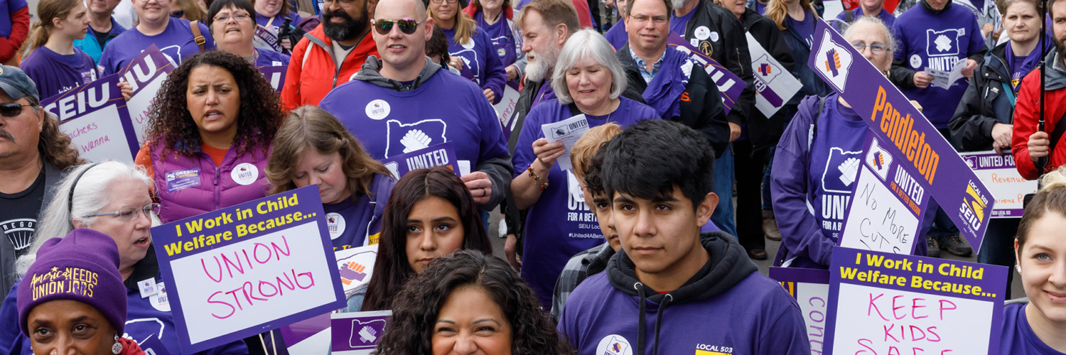 Members of the SEIU Chapter 503 labor union at a rally, all wearing purple union shirts.