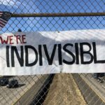 A Sign saying "we're Indivisible"
